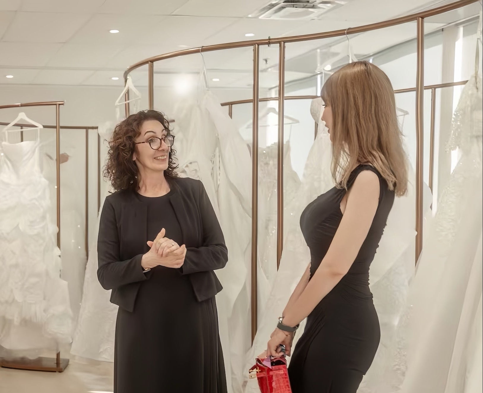 Bridal consultant helping a bride explore designer wedding dresses at Camellia Wedding Gown in Toronto.