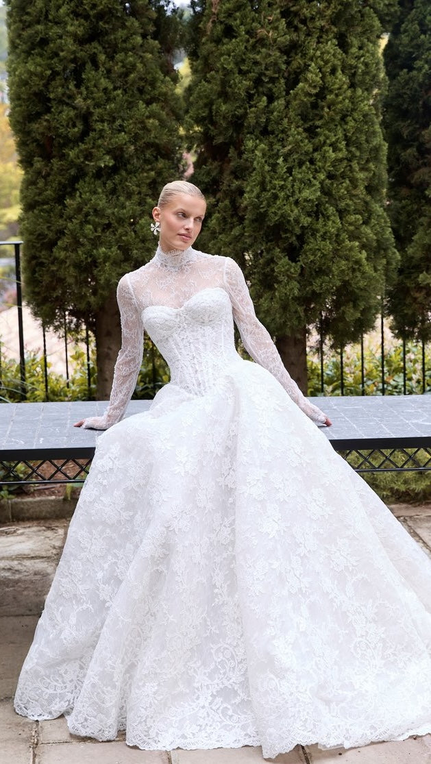 Close-up of a white lace wedding dress with a blurred background