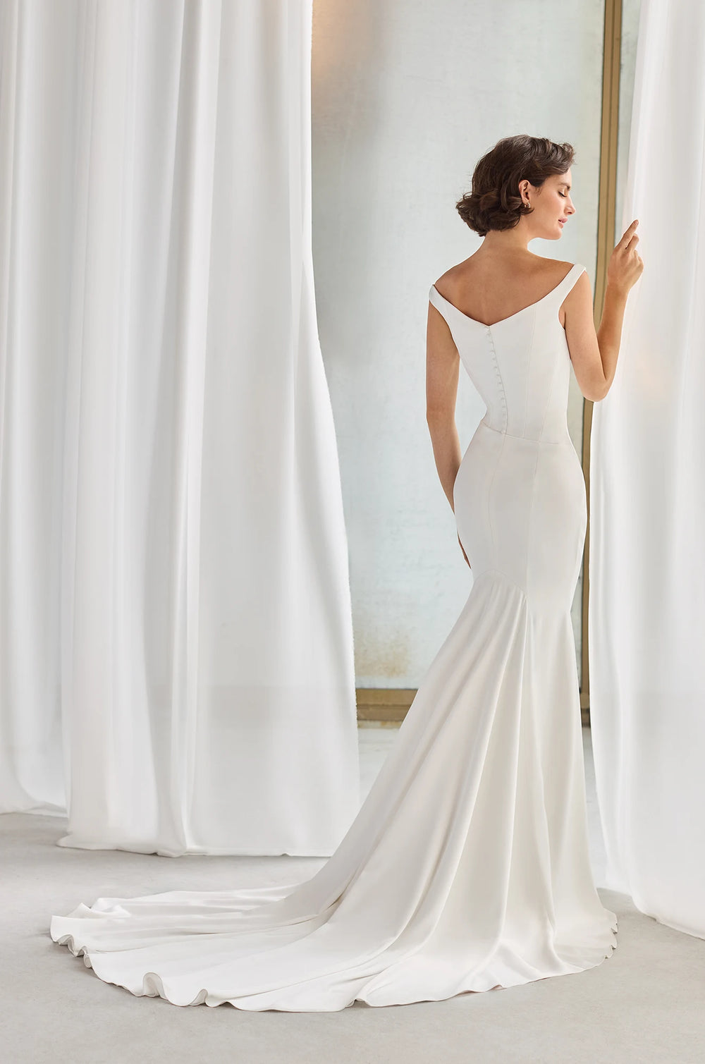 Paloma Blanca P5211 Off shoulder straps elegant Wedding Dress with Fit and flare bridal gown cutting and button details in the back available at camellia wedding gown