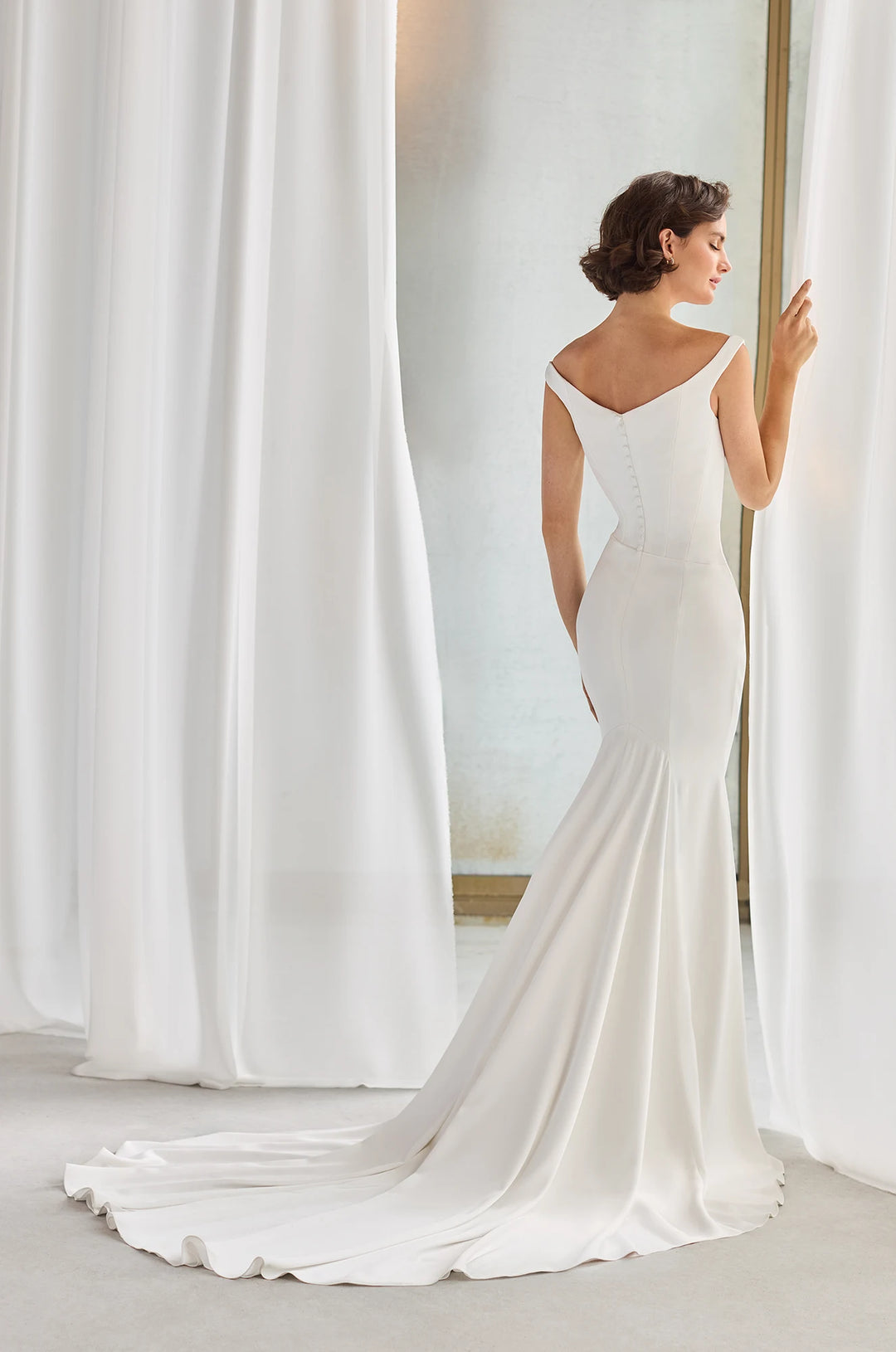 Paloma Blanca P5211 Off shoulder straps elegant Wedding Dress with Fit and flare bridal gown cutting and button details in the back available at camellia wedding gown