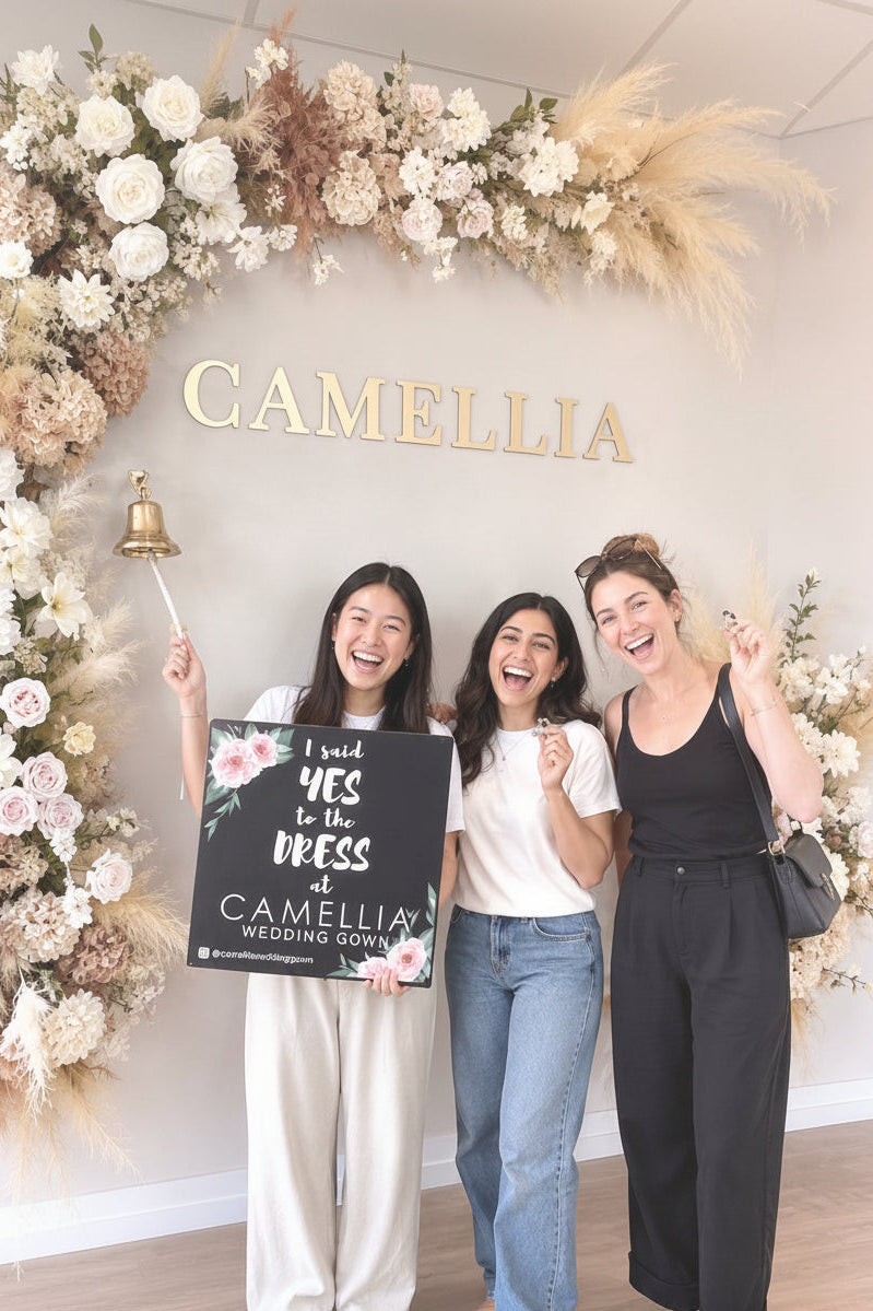 Brides celebrating after saying yes to the dress at Camellia Wedding Gown bridal boutique in North York, Toronto.