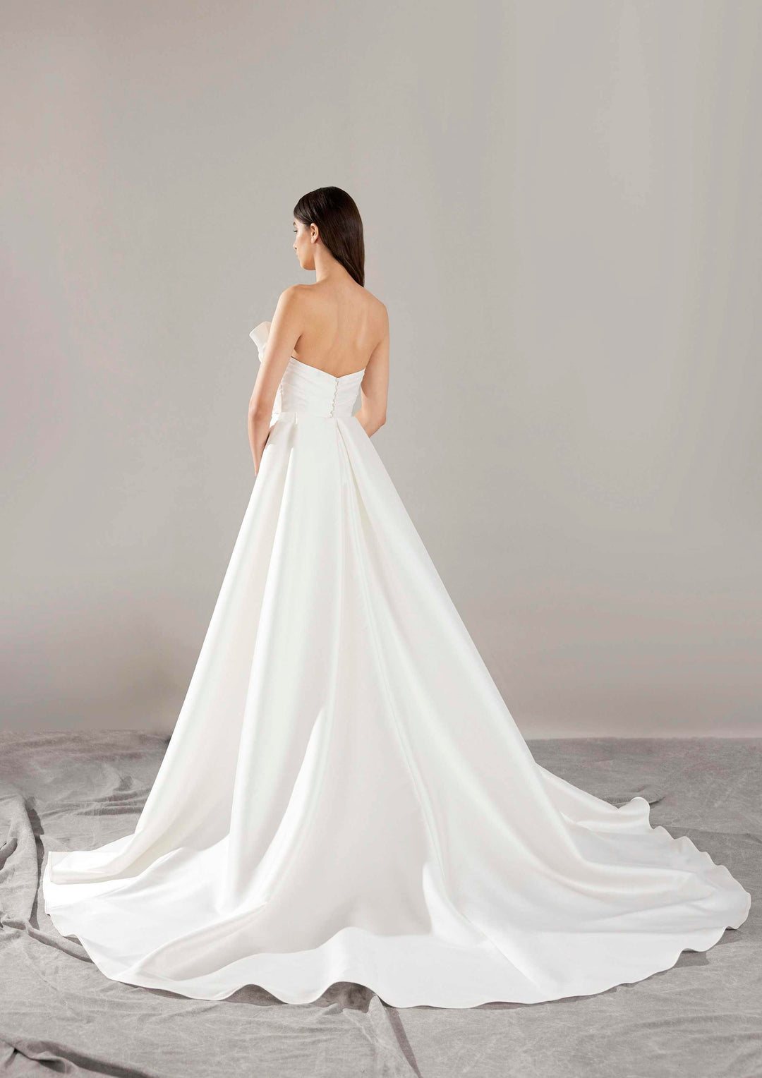 Pronovias Arya strapless mermaid wedding dress with overskirt back view