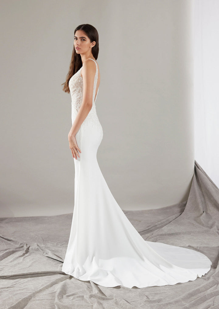 Pronovias Clin fitted wedding dress with beaded neckline and low back train view