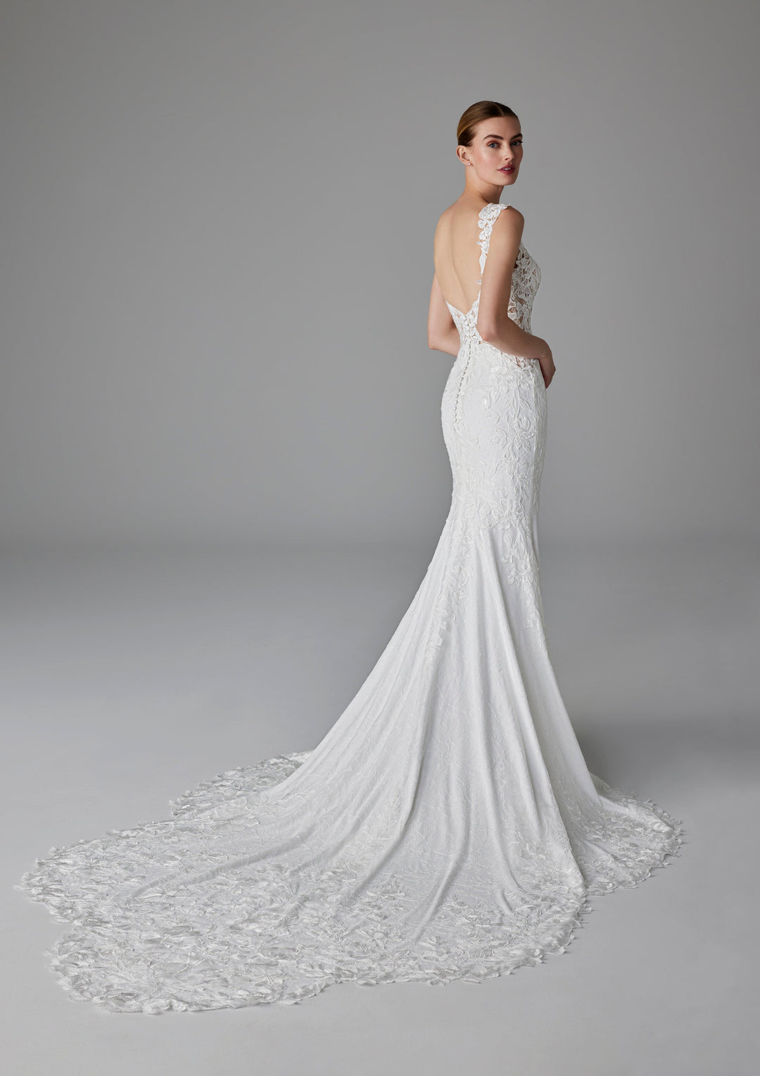 Pronovias Dion fitted wedding dress with floral appliqué train view
