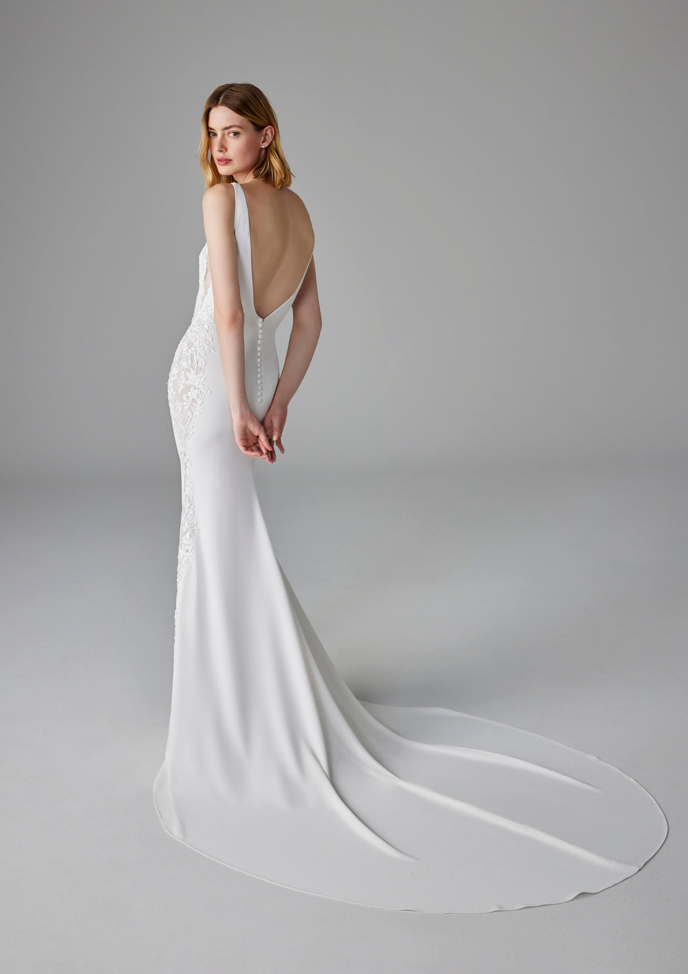 Pronovias Elea fitted crepe wedding dress v-neck low back train view